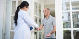 A man shaking hands with a doctor, symbolizing trust and collaboration in healthcare.