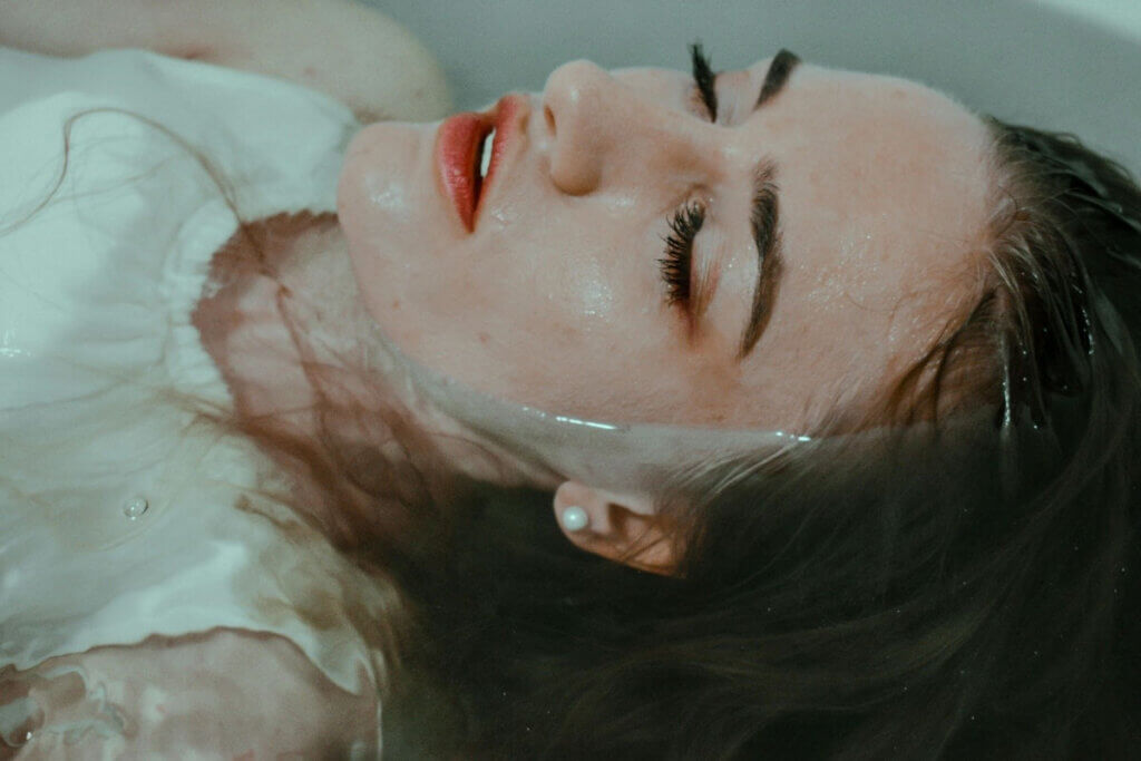 a woman lays in a bathtub