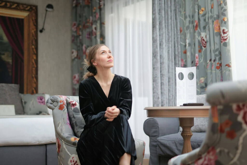 A woman sitting in a chair in her home.