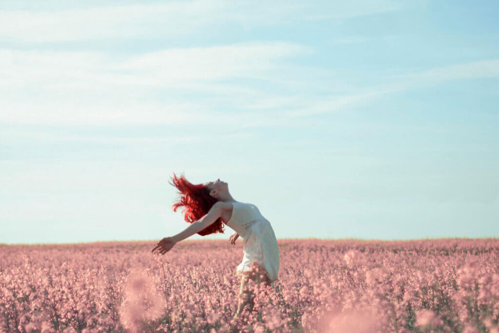 A woman in a field of flowers.