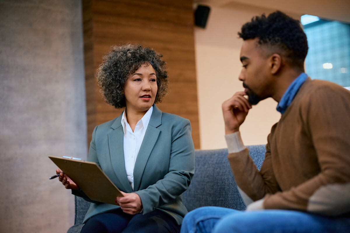 Insurance agent and her client talking terms of a contract during the meeting.
